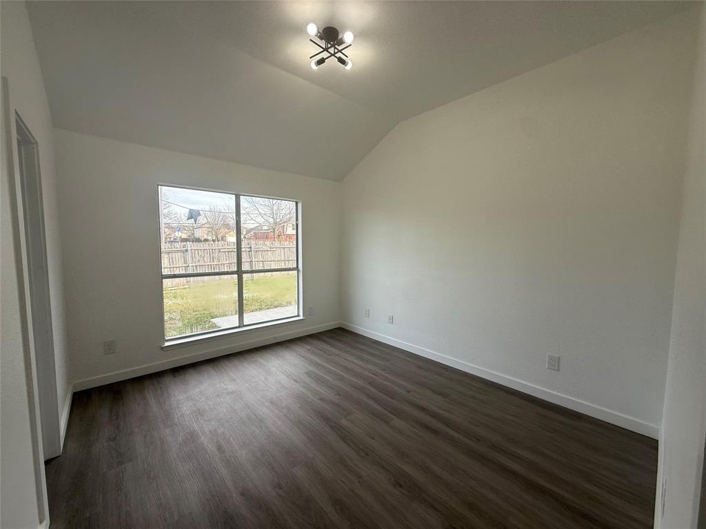 6005 Meadowdale Road Arlington, TX 76017 - Photo 14 of 20 a view of an empty room with wooden floor and a window