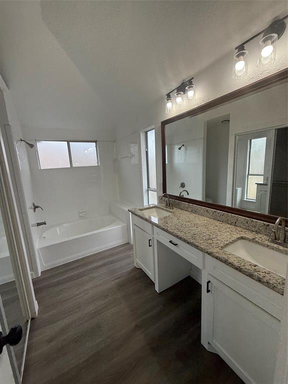 6005 Meadowdale Road Arlington, TX 76017 - Photo 15 of 20 a bathroom with a granite countertop sink a toilet a mirror and bathtub