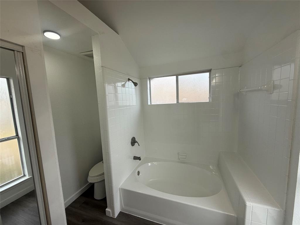 6005 Meadowdale Road Arlington, TX 76017 - Photo 17 of 20 a white bath tub sitting next to a window