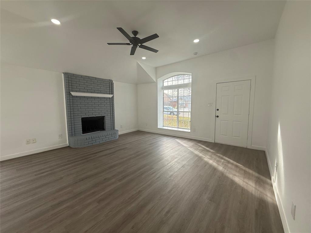 6005 Meadowdale Road Arlington, TX 76017 - Photo 4 of 20 an empty room with windows and fireplace