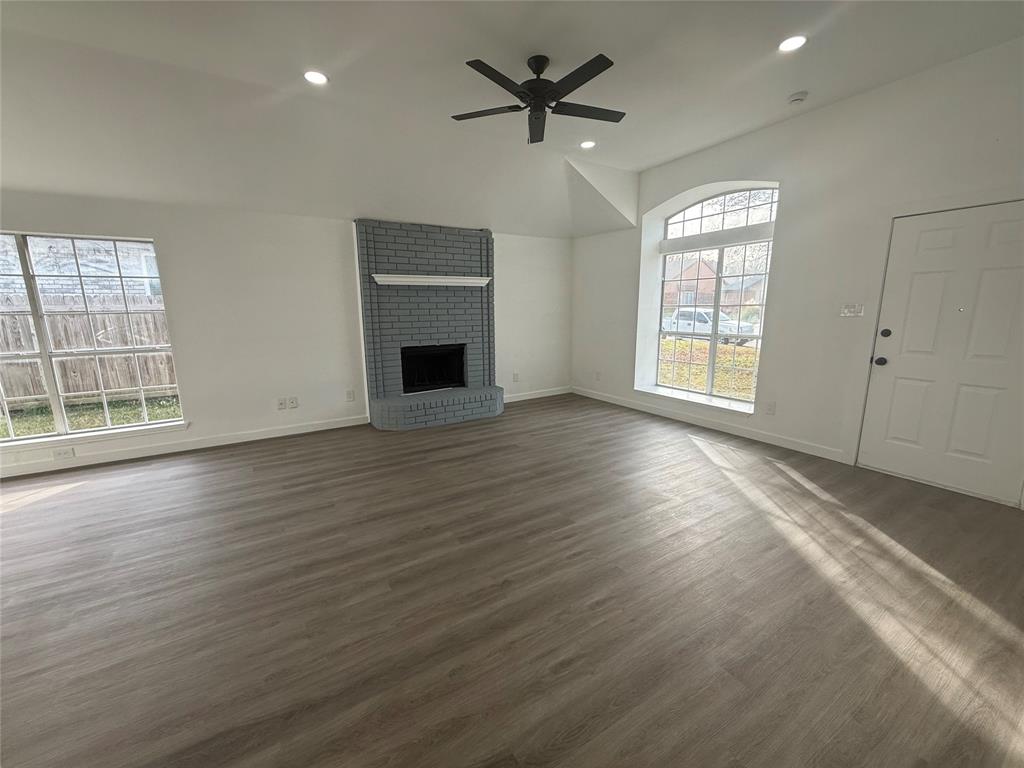 6005 Meadowdale Road Arlington, TX 76017 - Photo 5 of 20 a view of an empty room with a window and wooden floor