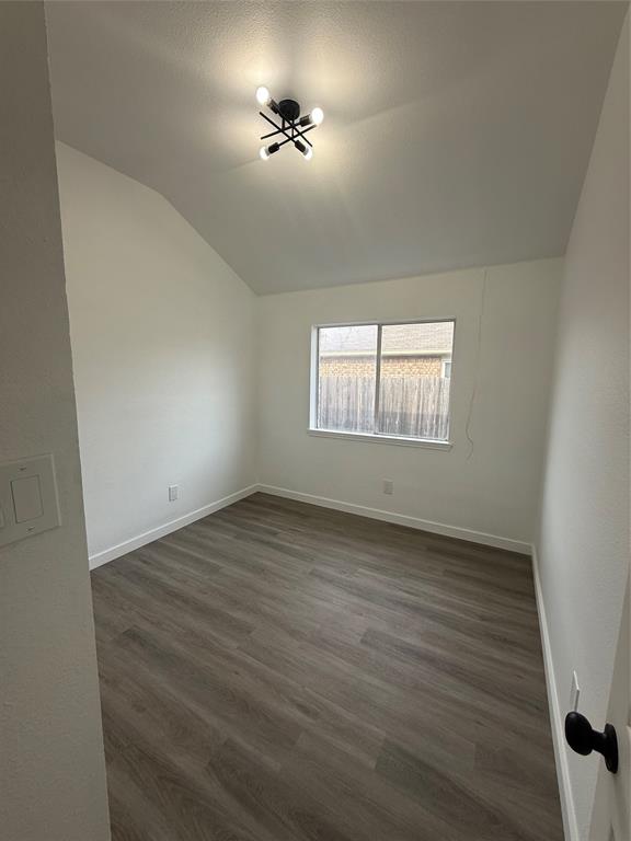 6005 Meadowdale Road Arlington, TX 76017 - Photo 9 of 20 wooden floor in an empty room with a window