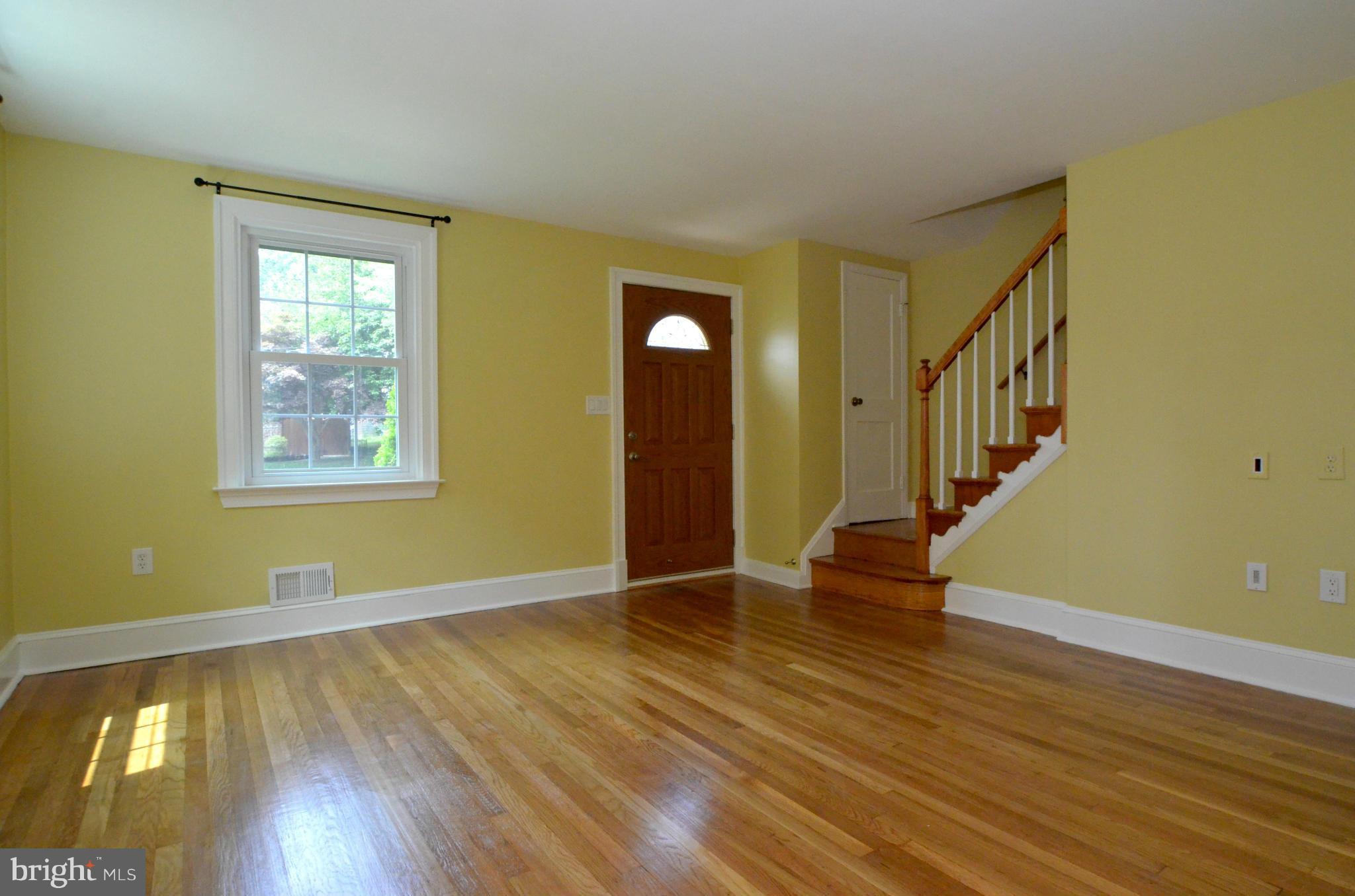 8649 Oak Road Baltimore, MD 21234 - Photo 2 of 30 a view of an empty room with wooden floor and a window