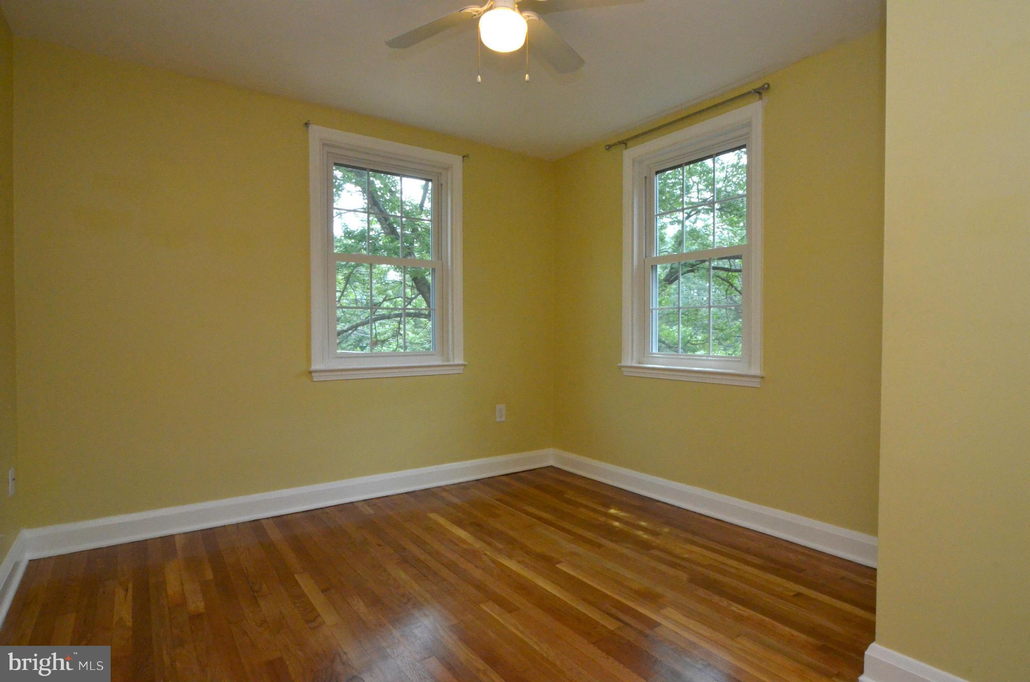 8649 Oak Road Baltimore, MD 21234 - Photo 12 of 30 a view of an empty room with wooden floor and a window