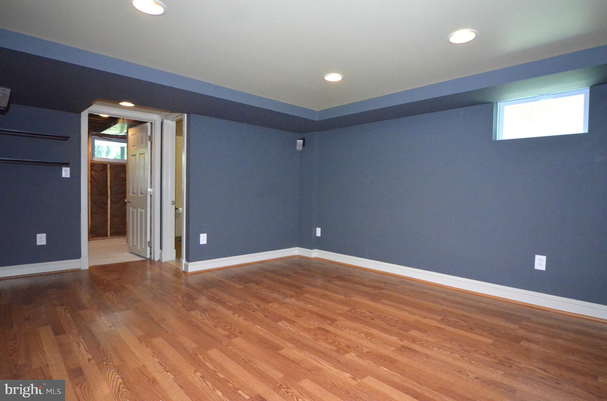 8649 Oak Road Baltimore, MD 21234 - Photo 17 of 30 an empty room with wooden floor and windows