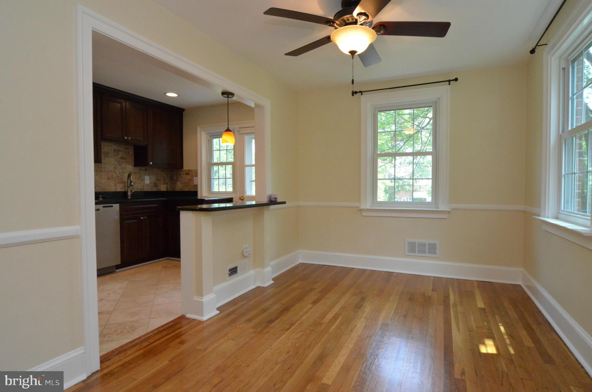 8649 Oak Road Baltimore, MD 21234 - Photo 6 of 30 an empty room with wooden floor cabinet and windows