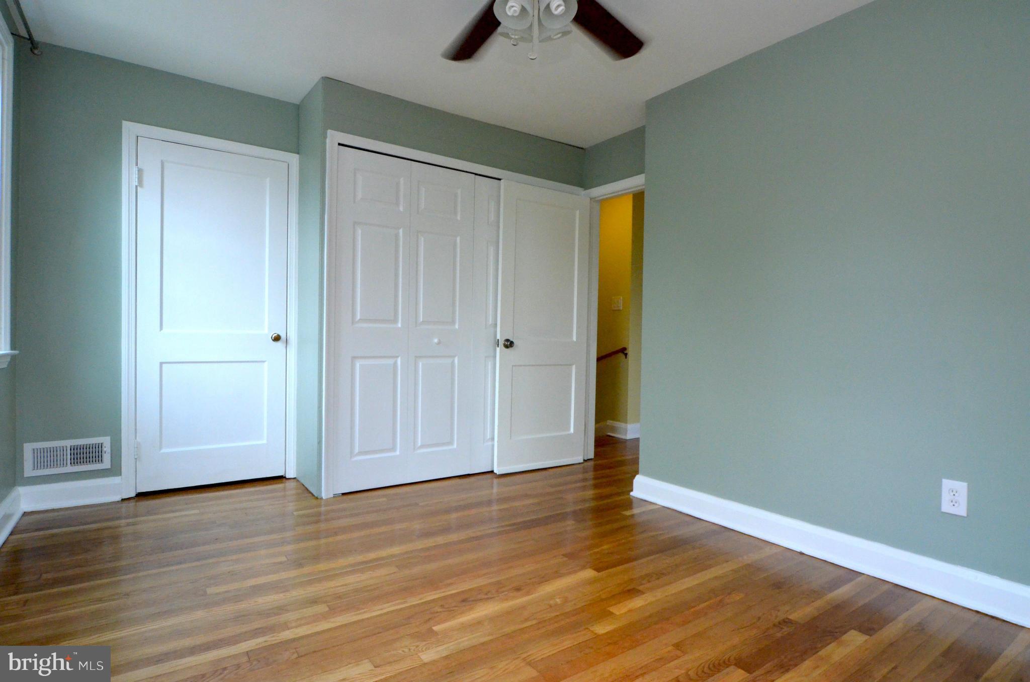 8649 Oak Road Baltimore, MD 21234 - Photo 9 of 30 an empty room with wooden floor and door