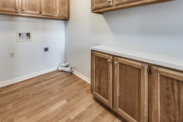 a view of a closet area with wooden floor