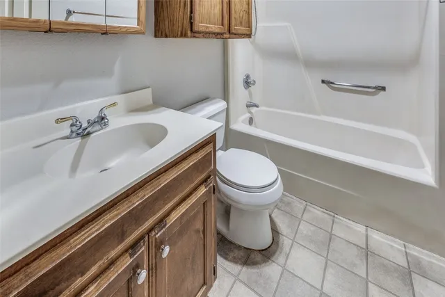 a bathroom with a sink a toilet and bathtub