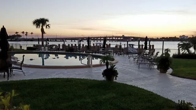 a view of a swimming pool with a table and chairs