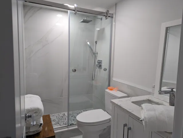 a bathroom with a sink toilet and shower