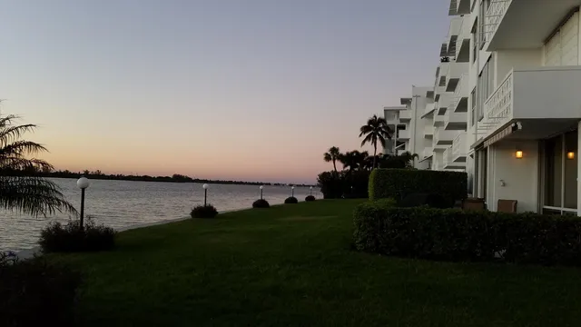 a view of a house with backyard and lake