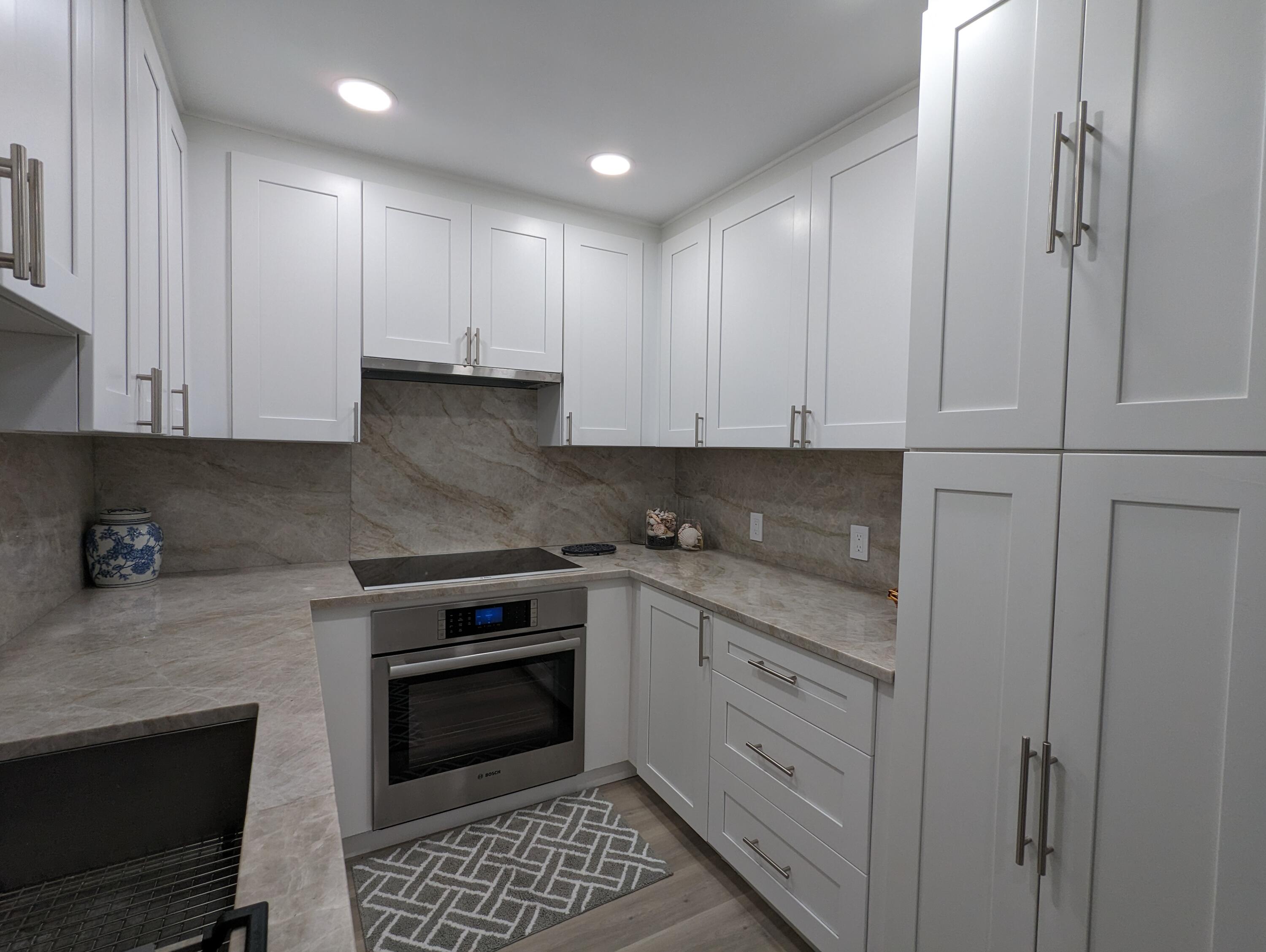 2840 South Ocean Boulevard, Unit 3230 Palm Beach, FL 33480 - Photo 4 of 18 a kitchen with stainless steel appliances granite countertop a stove a sink and a refrigerator