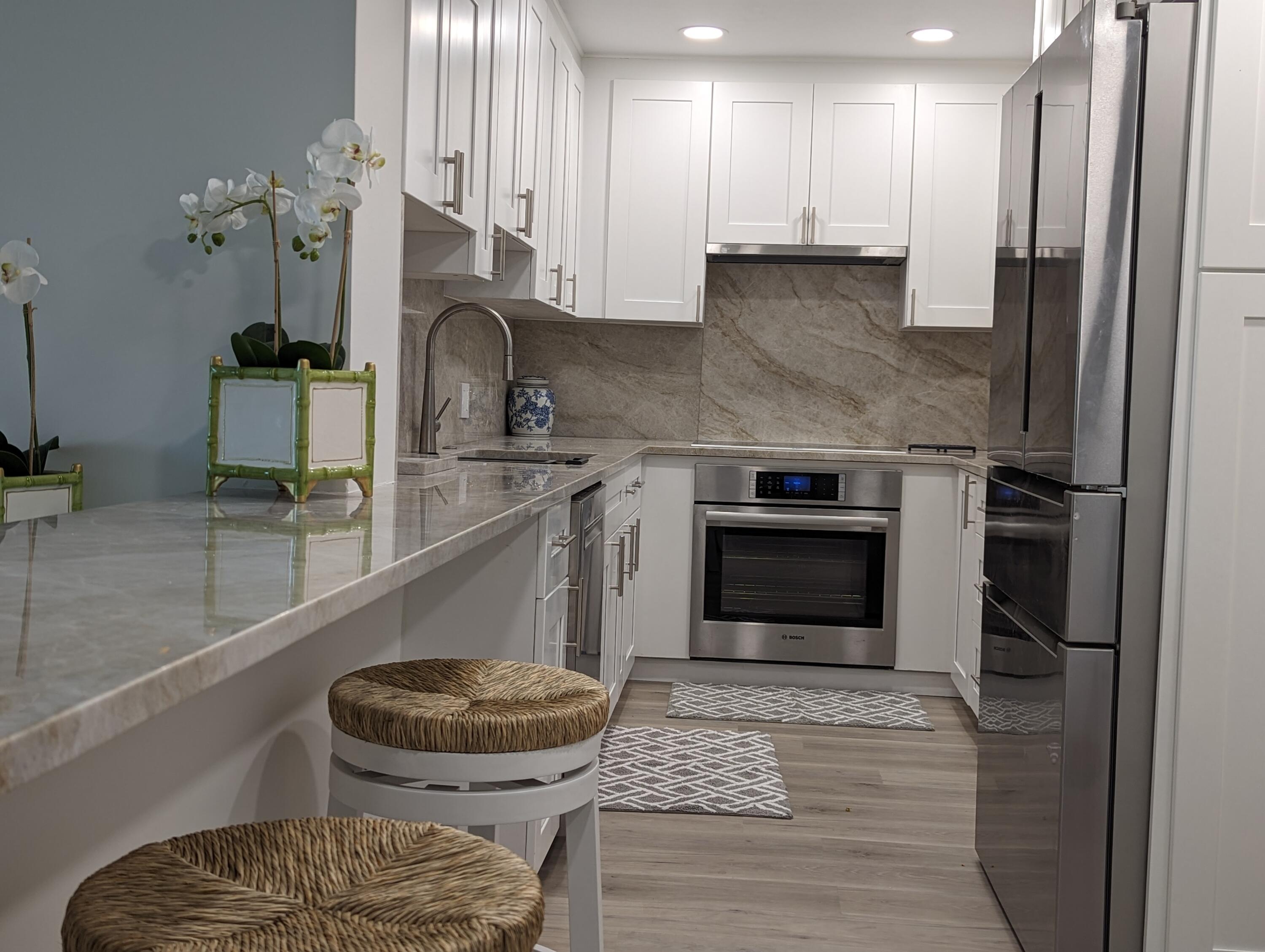 2840 South Ocean Boulevard, Unit 3230 Palm Beach, FL 33480 - Photo 5 of 18 a kitchen with stainless steel appliances granite countertop a stove a sink and a refrigerator