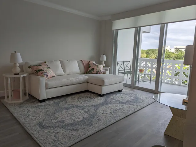 a living room with furniture and large windows