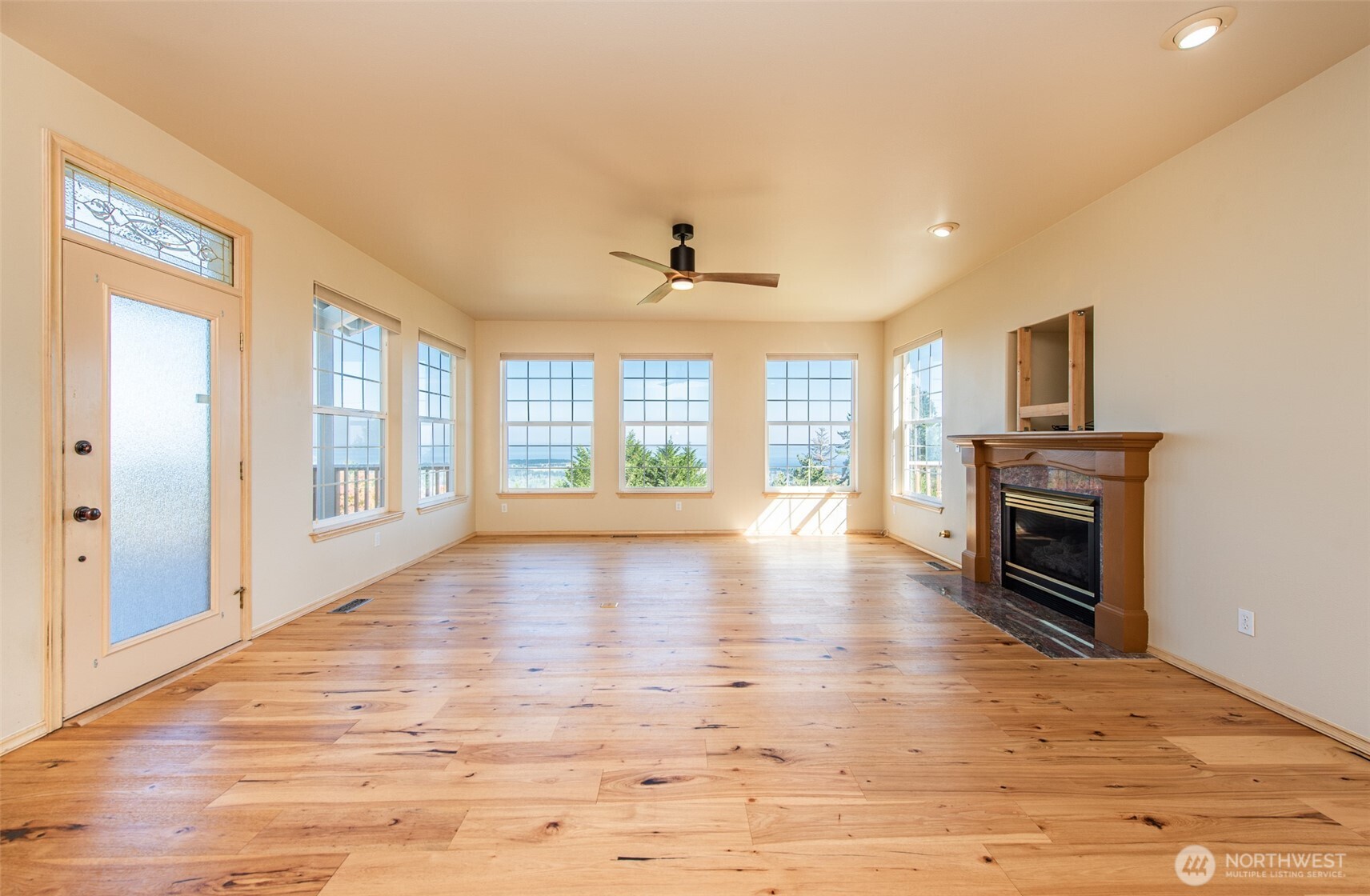 113 Quails Roost Road Sequim, WA 98382 - Photo 19 of 40 a view of an empty room with a window and wooden floor