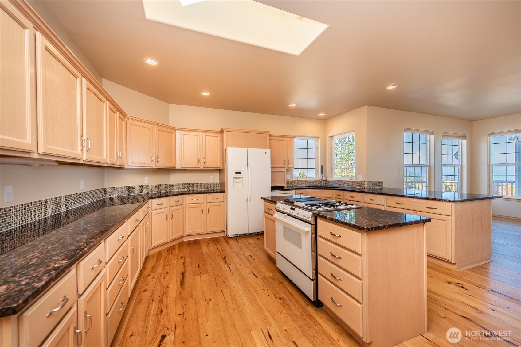 113 Quails Roost Road Sequim, WA 98382 - Photo 24 of 40 a kitchen with stainless steel appliances granite countertop a stove and a sink
