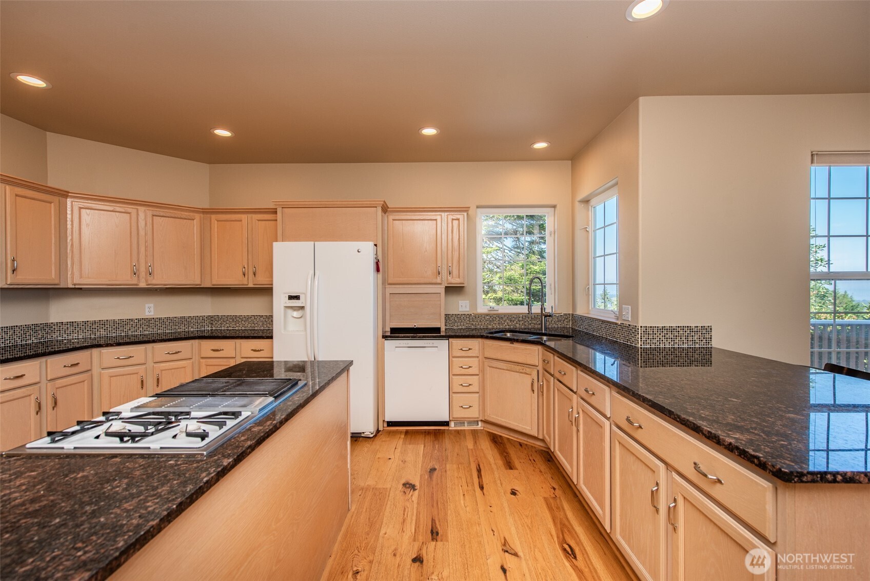113 Quails Roost Road Sequim, WA 98382 - Photo 26 of 40 a kitchen with granite countertop a sink stove and refrigerator