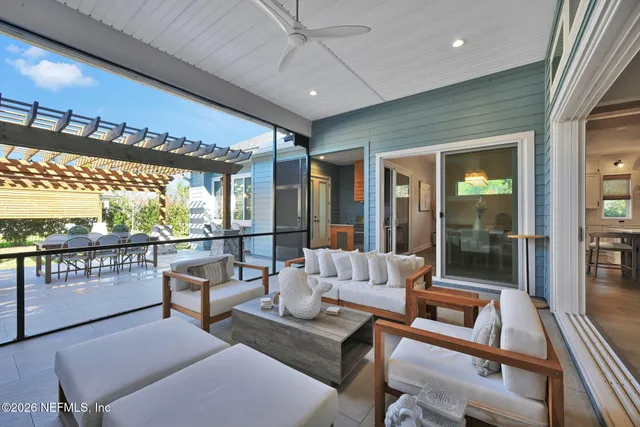 a view of a house with a yard deck and a large tree