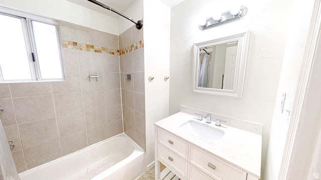 205 East Center Street Salem, UT 84653 - Photo 17 of 40 Bathroom featuring a white vanity with a light-colored countertop, framed mirror, and a tub-shower combination with tiled walls