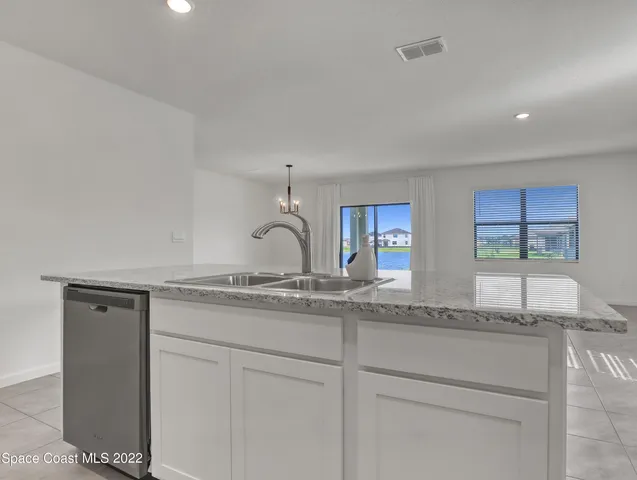 a kitchen with granite countertop stainless steel appliances white cabinets and a granite counter tops