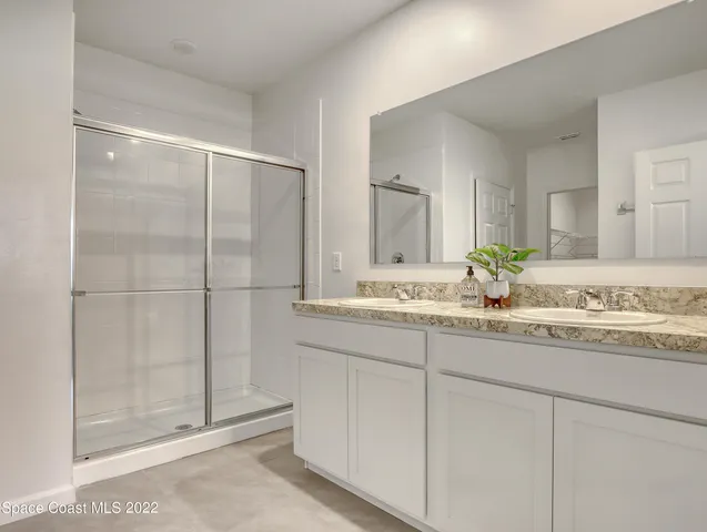 a view of a big house with a big yard and potted plants