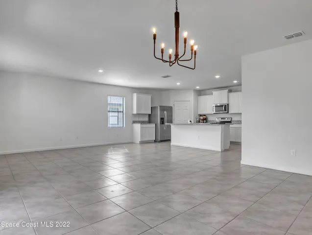 a view of a kitchen with a sink stainless steel appliances and cabinets