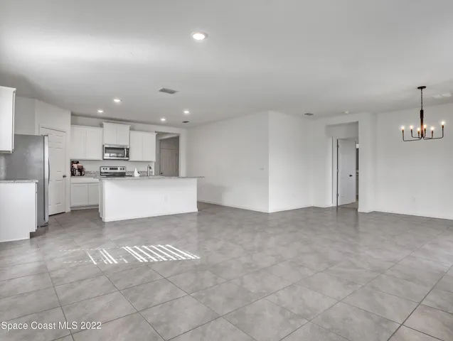 a view of a kitchen with a sink and cabinets