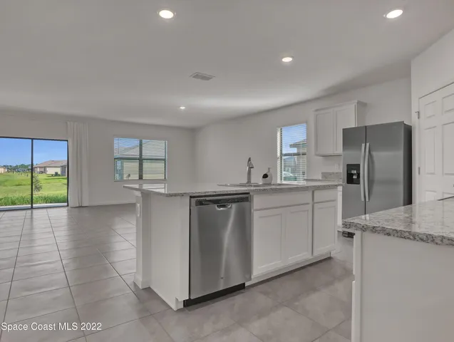 a kitchen with refrigerator and window