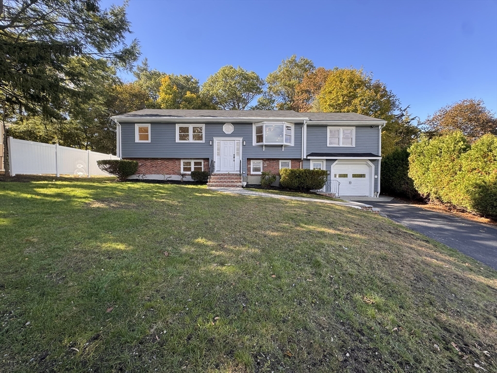 38 Middle Street Woburn, MA 01801 - Photo 1 of 39 a view of a yard in front of a house with large tree