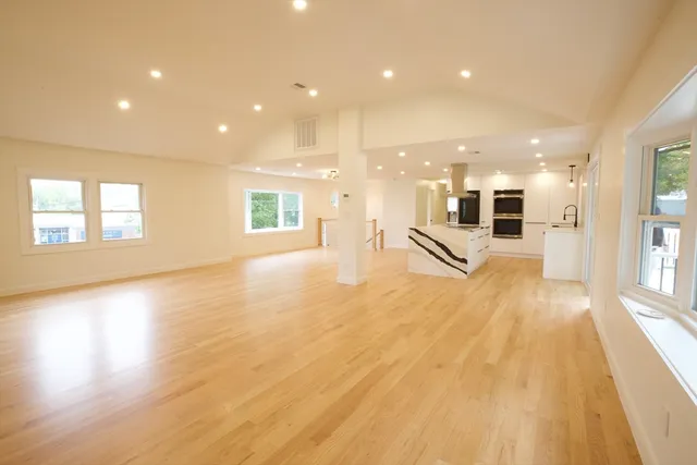 a view of a kitchen with kitchen island granite countertop a large window