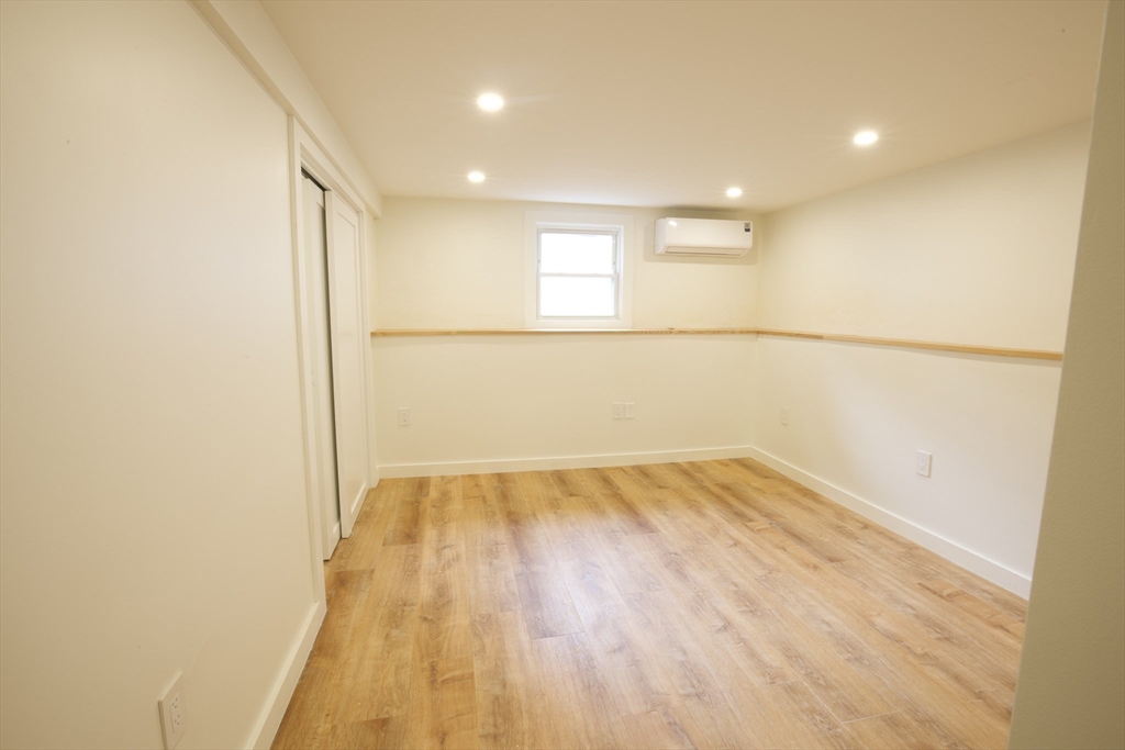 38 Middle Street Woburn, MA 01801 - Photo 12 of 39 a view of an empty room with wooden floor and a window