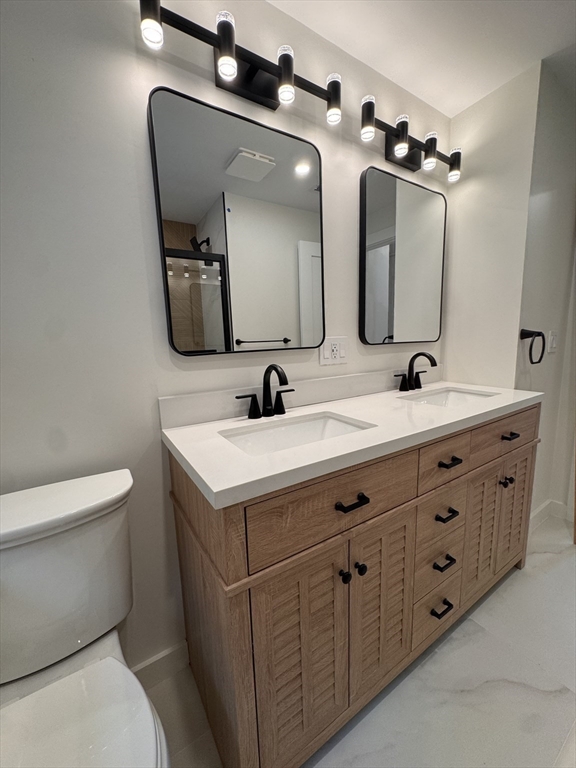 38 Middle Street Woburn, MA 01801 - Photo 20 of 39 a bathroom with a double vanity sink and a mirror