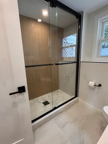 a bathroom with a shower and toilet