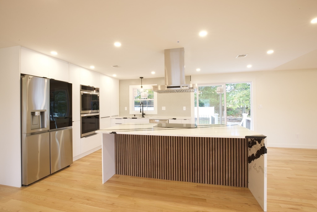 38 Middle Street Woburn, MA 01801 - Photo 3 of 39 a kitchen with stainless steel appliances granite countertop a sink and cabinets