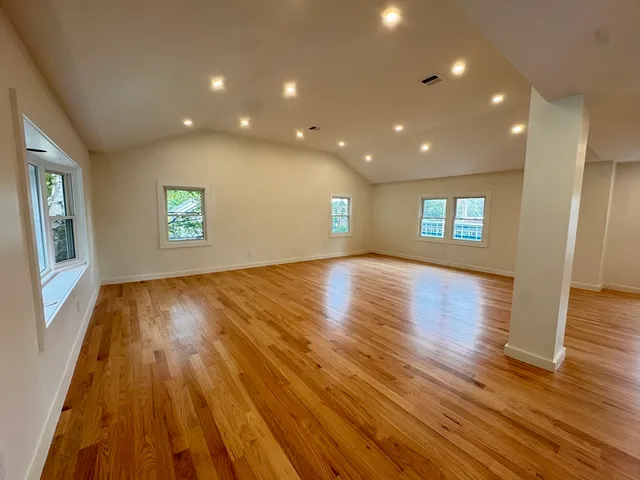 a view of wooden floor and windows in an empty room