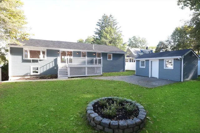 a view of a house with a backyard
