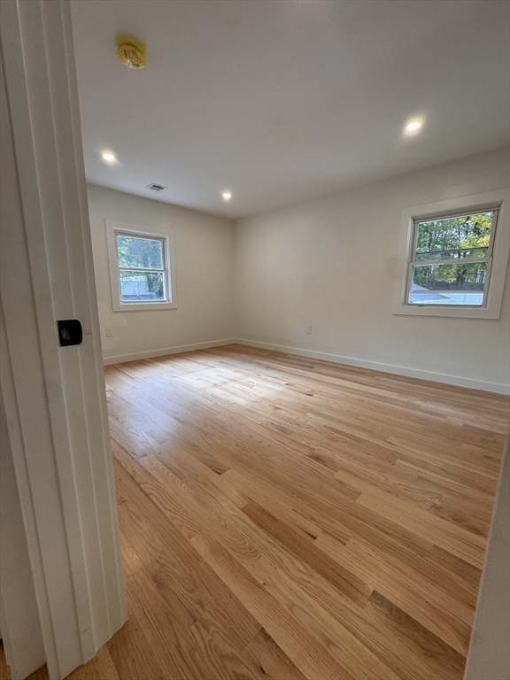 38 Middle Street Woburn, MA 01801 - Photo 7 of 39 an empty room with wooden floor and windows
