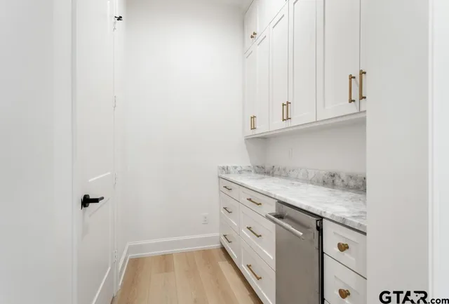a kitchen with granite countertop white cabinets and white appliances