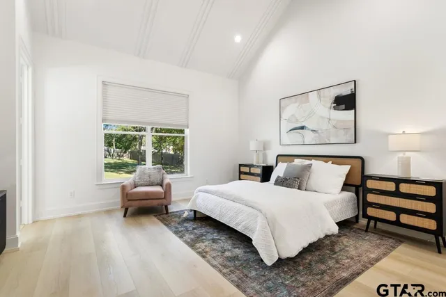 a bedroom with a bed and a large window