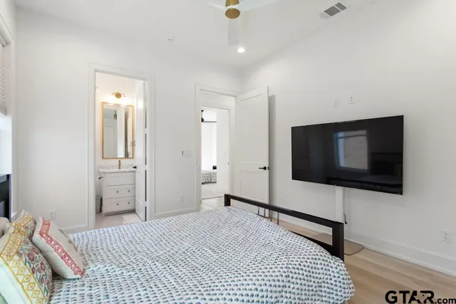 a bedroom with a bed and a flat screen tv