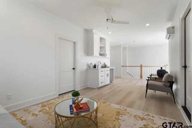 a living room with furniture and wooden floor