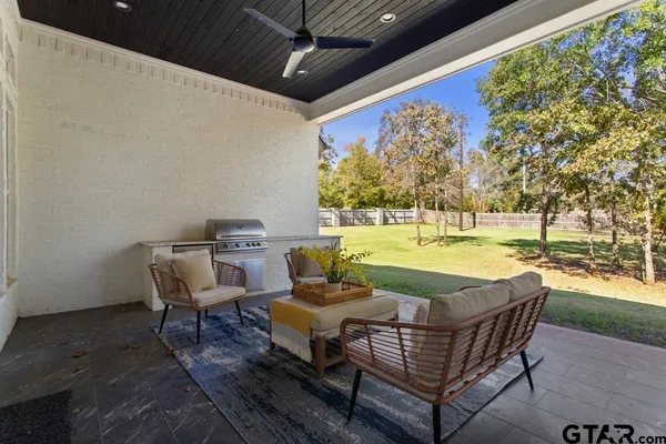 a view of swimming pool with outdoor seating and yard