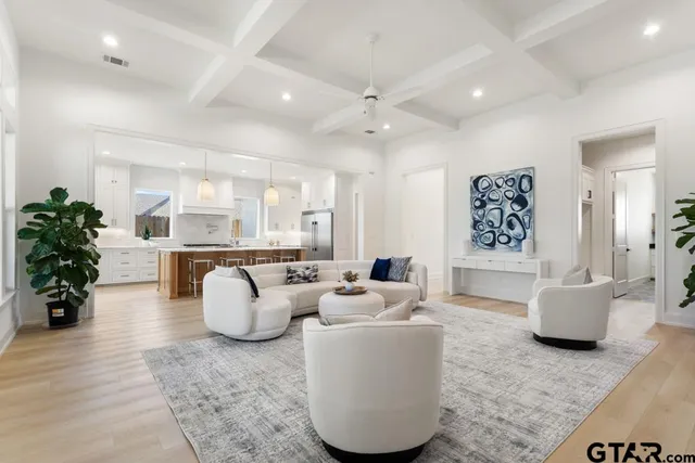a living room with fireplace furniture and a potted plant