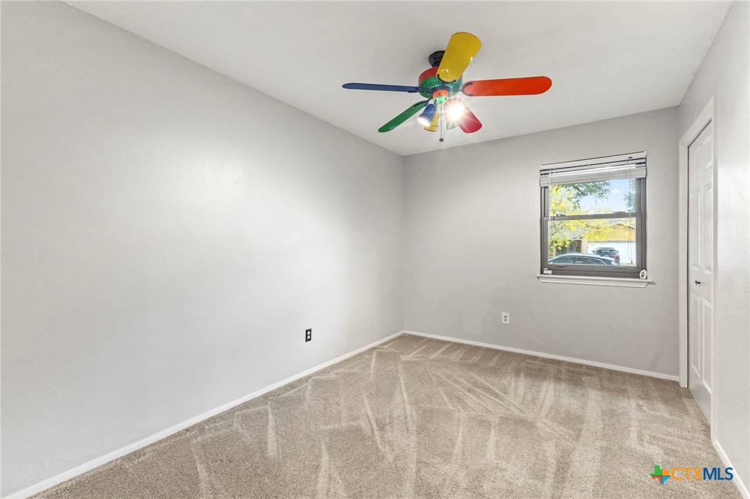 413 Suzzane Road Pflugerville, TX 78660 - Photo 15 of 23 Bedroom featuring light carpet and ceiling fan