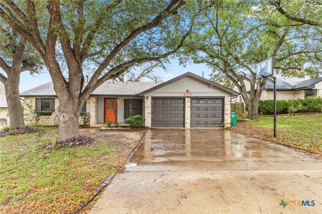 413 Suzzane Road Pflugerville, TX 78660 - Photo 21 of 23 Ranch style home featuring a front entry garage and large shade trees