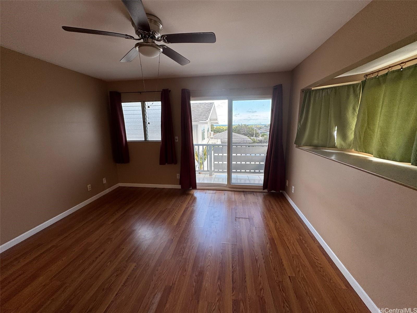 541 Kuliouou Road Honolulu, HI 96821 - Photo 17 of 21 a view of an empty room with wooden floor and a window