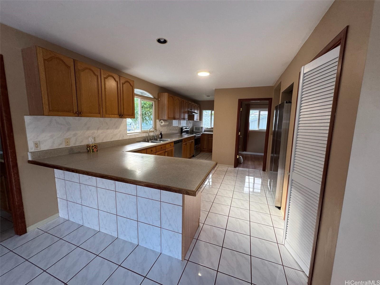 541 Kuliouou Road Honolulu, HI 96821 - Photo 7 of 21 a kitchen with granite countertop a sink a stove and cabinets