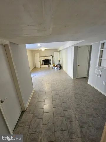 a view of a livingroom with furniture and an empty room