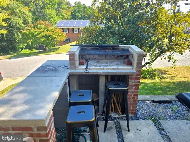 a wooden bench sitting in a yard next to a yard